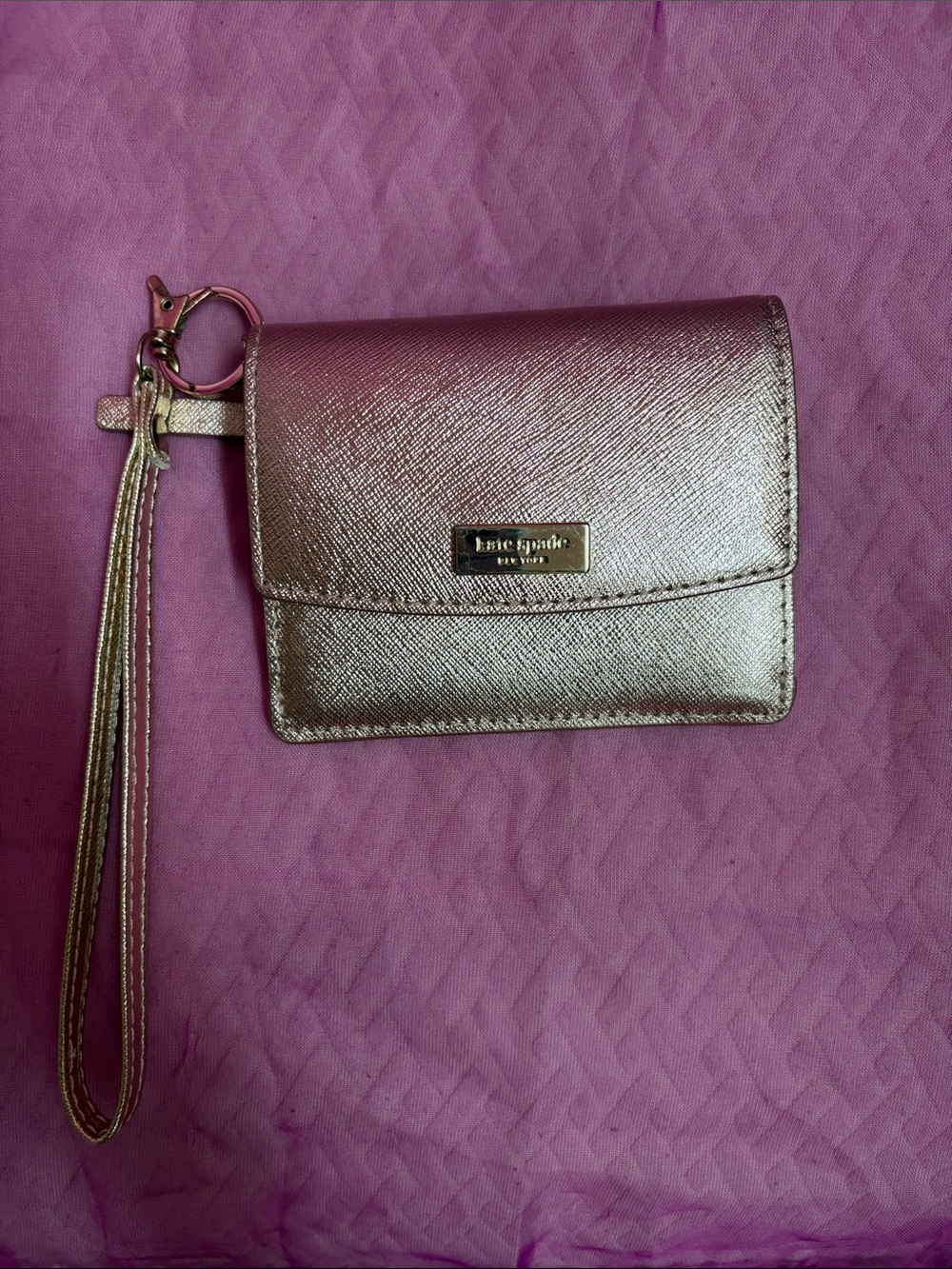 kate spade metallic rose gold wristlet card holder with tassel